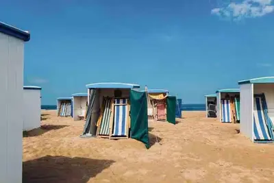 a row of tents on a sandy beach at Logies at the sea in Katwijk aan Zee