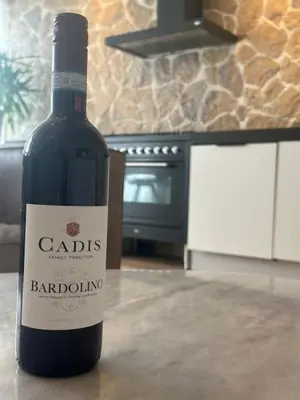 a bottle of wine sitting on a counter in a kitchen at Romantic jacuzzi suite in the city center in Bodegraven