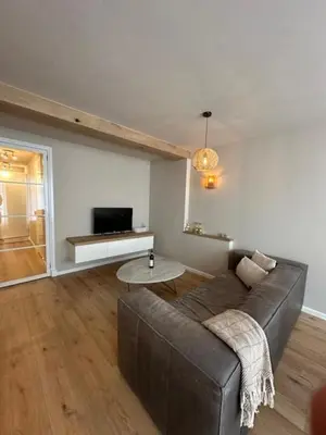 a living room with a couch and a table at Romantic jacuzzi suite in the city center in Bodegraven