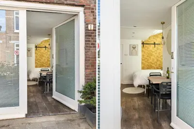 a room with two beds and a table with chairs at 2P studio in Utrecht city center in Utrecht