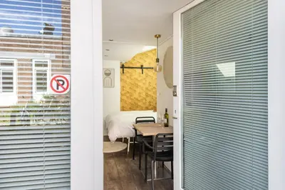 a room with a table and a bed and a window at 2P studio in Utrecht city center in Utrecht