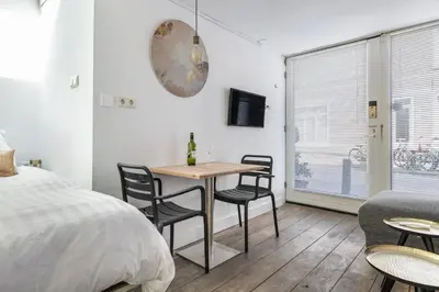 a bedroom with a table and chairs and a bed at 2P studio in Utrecht city center in Utrecht