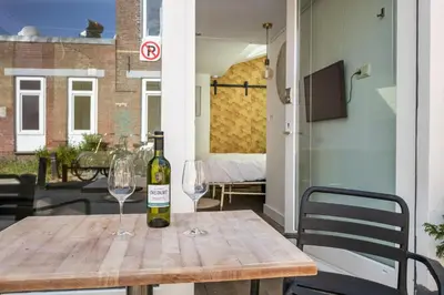 a bottle of wine on a wooden table with two glasses at 2P studio in Utrecht city center in Utrecht