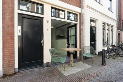 a table and chairs on a sidewalk next to a building at Beautiful 'tiny-house' in Utrecht City Center in Utrecht