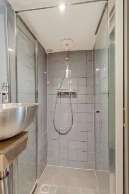 a bathroom with a sink and a shower at Beautiful 'tiny-house' in Utrecht City Center in Utrecht