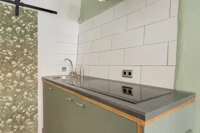 a kitchen with a sink and a counter top at Beautiful 'tiny-house' in Utrecht City Center in Utrecht