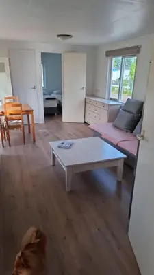 a living room with a couch and a coffee table at Family Friendly Holiday Chalet with Pool in Holiday Park in Opmeer