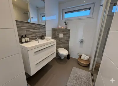 a bathroom with a white sink and a toilet at Villa Sea Side am Markermeer Modernes Waterfront Haus 6 Pers in Bovenkarspel