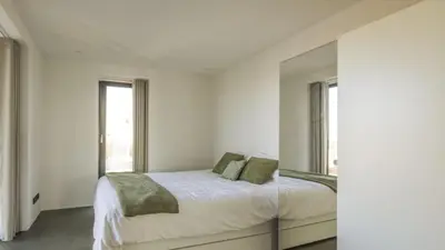 a bedroom with a bed and a large mirror at Super View Penthouse Deluxe in Amsterdam