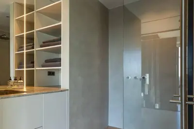 a bathroom with a shower and a glass door at Super View Penthouse Deluxe in Amsterdam