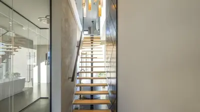 a wooden staircase in a house with glass walls at Super View Penthouse Deluxe in Amsterdam