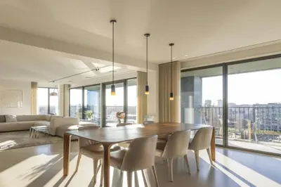 a dining room with a table and chairs and a couch at Super View Penthouse Deluxe in Amsterdam