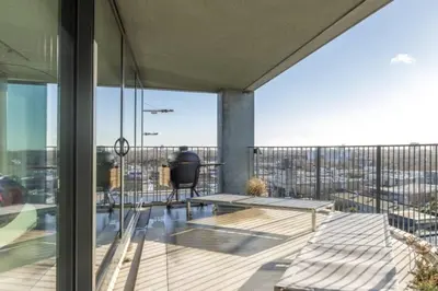 an apartment with a balcony with a view of the city at Super View Penthouse Deluxe in Amsterdam