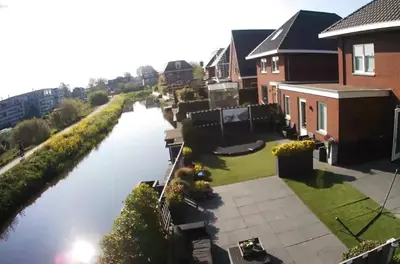 an aerial view of a river next to houses at Private apartment with garden, close to Amsterdam in Assendelft
