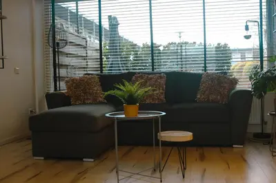 a living room with a couch and a table at Amsterdam Beach Home 88 in Zandvoort