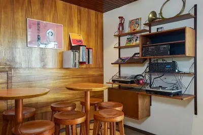 a restaurant with wooden tables and stools in a room at Pension Homeland in Amsterdam