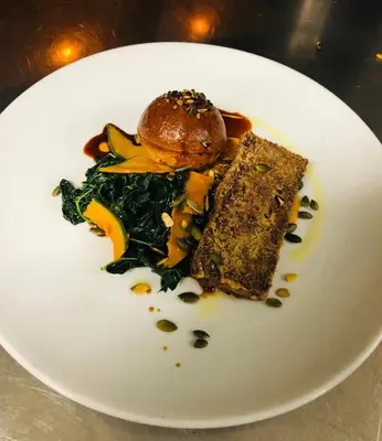 a white plate with a piece of food on it at Pension Homeland in Amsterdam