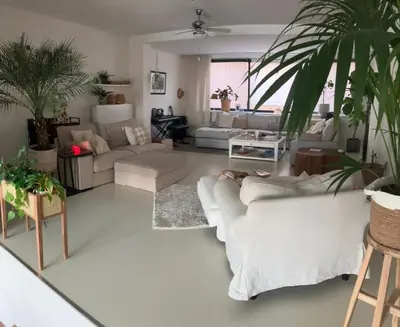 a living room with couches and plants in it at Spacious house IJmeer Amsterdam - east IJburg in Amsterdam