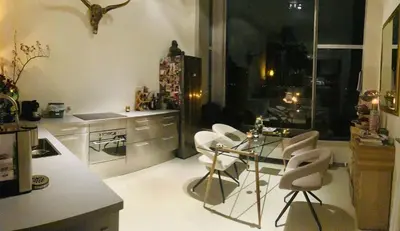 a kitchen with a glass table and white chairs at Spacious house IJmeer Amsterdam - east IJburg in Amsterdam