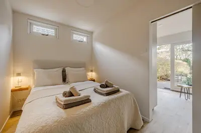 a bedroom with a bed with two towels on it at Green Heart Apartment Private Parking in Zandvoort