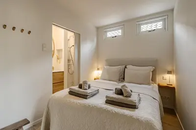 a bedroom with a bed with two towels on it at Green Heart Apartment Private Parking in Zandvoort