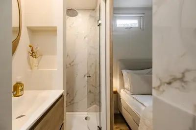 a bathroom with a shower and a sink and a toilet at Green Heart Apartment Private Parking in Zandvoort