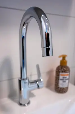 a sink with a toothbrush and a soap dispenser on it at 10 persons Tulpenacker Comfort in Roelofarendsveen