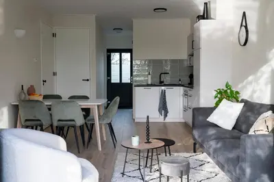 a living room with a couch and a table at 10 persons Tulpenacker Comfort in Roelofarendsveen