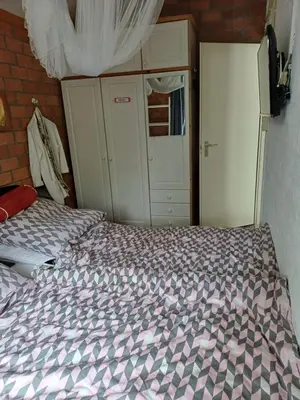 a bedroom with a bed with a purple comforter at Ferienhaus Müller in Burgerbrug