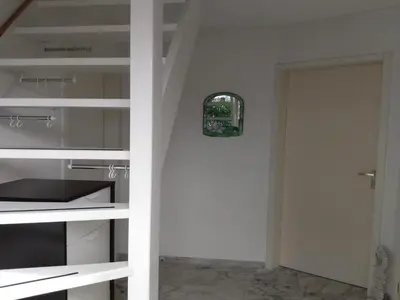a kitchen with white shelves and a door at Cozy holiday home in Burgerbrug in Burgerbrug