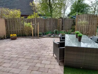 a patio with a table and chairs and a fence at Cozy holiday home in Burgerbrug in Burgerbrug