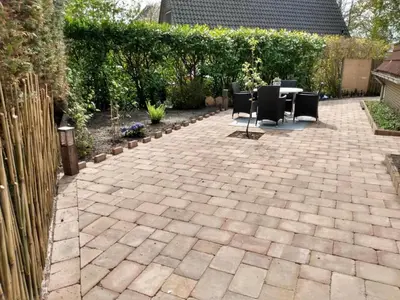 a patio with chairs and a table in a garden at Cozy holiday home in Burgerbrug in Burgerbrug
