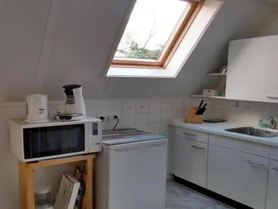 a kitchen with a microwave and a sink at Cozy holiday home in Burgerbrug in Burgerbrug