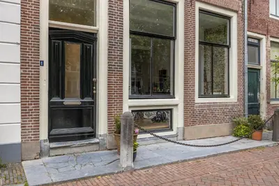 a building with a fire hydrant in front of it at Luxury Studio in Utrecht Center - view on canal in Utrecht