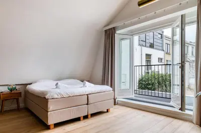 a bedroom with a bed and a large window at Luxury Spacious Studio in Utrecht City Center in Utrecht
