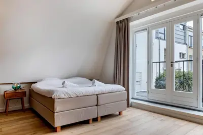 a bedroom with a bed and a large window at Luxury Spacious Studio in Utrecht City Center in Utrecht