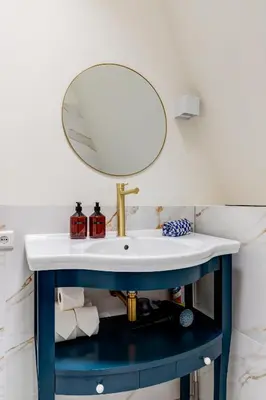 a bathroom with a blue sink and a mirror at Luxury Spacious Studio in Utrecht City Center in Utrecht