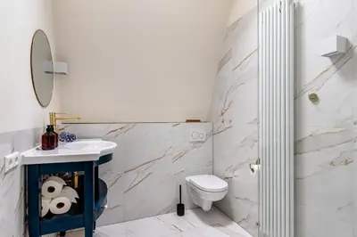 a bathroom with a white toilet and a sink at Luxury Spacious Studio in Utrecht City Center in Utrecht