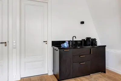 a kitchen with a black counter and a sink at 2 Luxurious Studios in Utrecht City Center in Utrecht