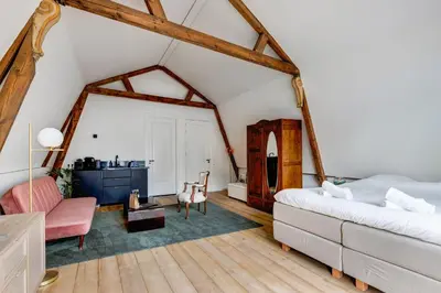 a bedroom with a bed and a living room at 2 Luxurious Studios in Utrecht City Center in Utrecht