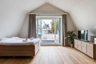a bedroom with a bed and a large window at 2 Luxurious Studios in Utrecht City Center in Utrecht