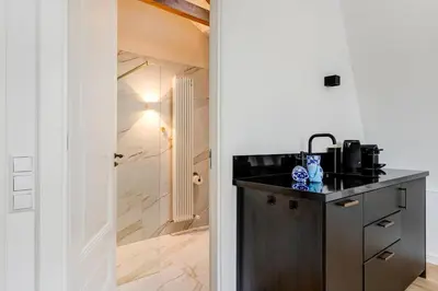 a kitchen with a black counter and a sink at 2 Luxurious Studios in Utrecht City Center in Utrecht