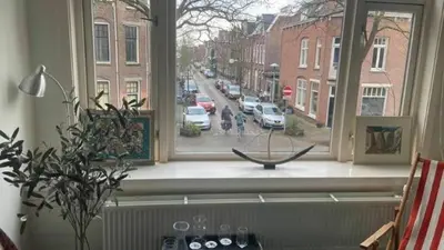 a window with a view of a street with cars at Studio 11 in Utrecht