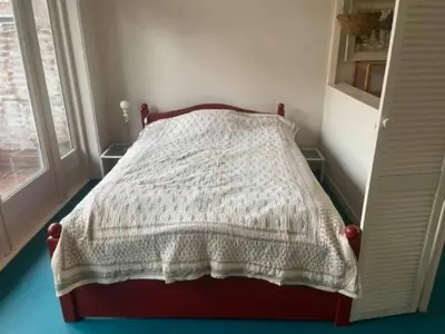 a bedroom with a bed with a blanket on it at Studio 11 in Utrecht