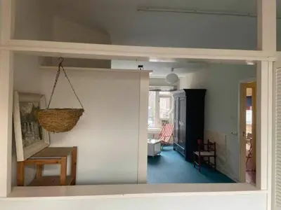 a living room with a basket hanging from a wall at Studio 11 in Utrecht