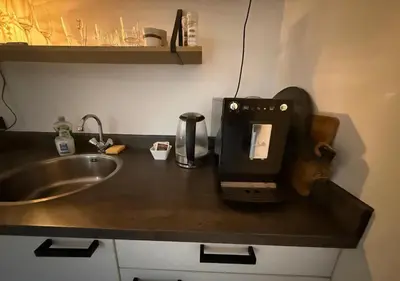 a kitchen counter with a coffee maker and a sink at Central Luxe Family Retreat in Amsterdam