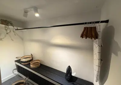 a room with a bench and baskets on a wall at Central Luxe Family Retreat in Amsterdam