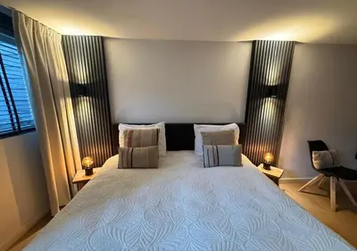 a bedroom with a large white bed with pillows at Central Luxe Family Retreat in Amsterdam