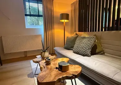a living room with a couch and a coffee table at Central Luxe Family Retreat in Amsterdam