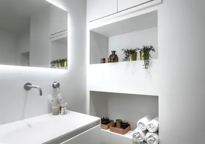 a white bathroom with a sink and a mirror at Central Luxe Family Retreat in Amsterdam